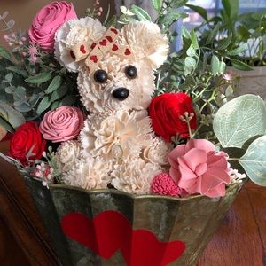 Sola wood pup in flower filled container